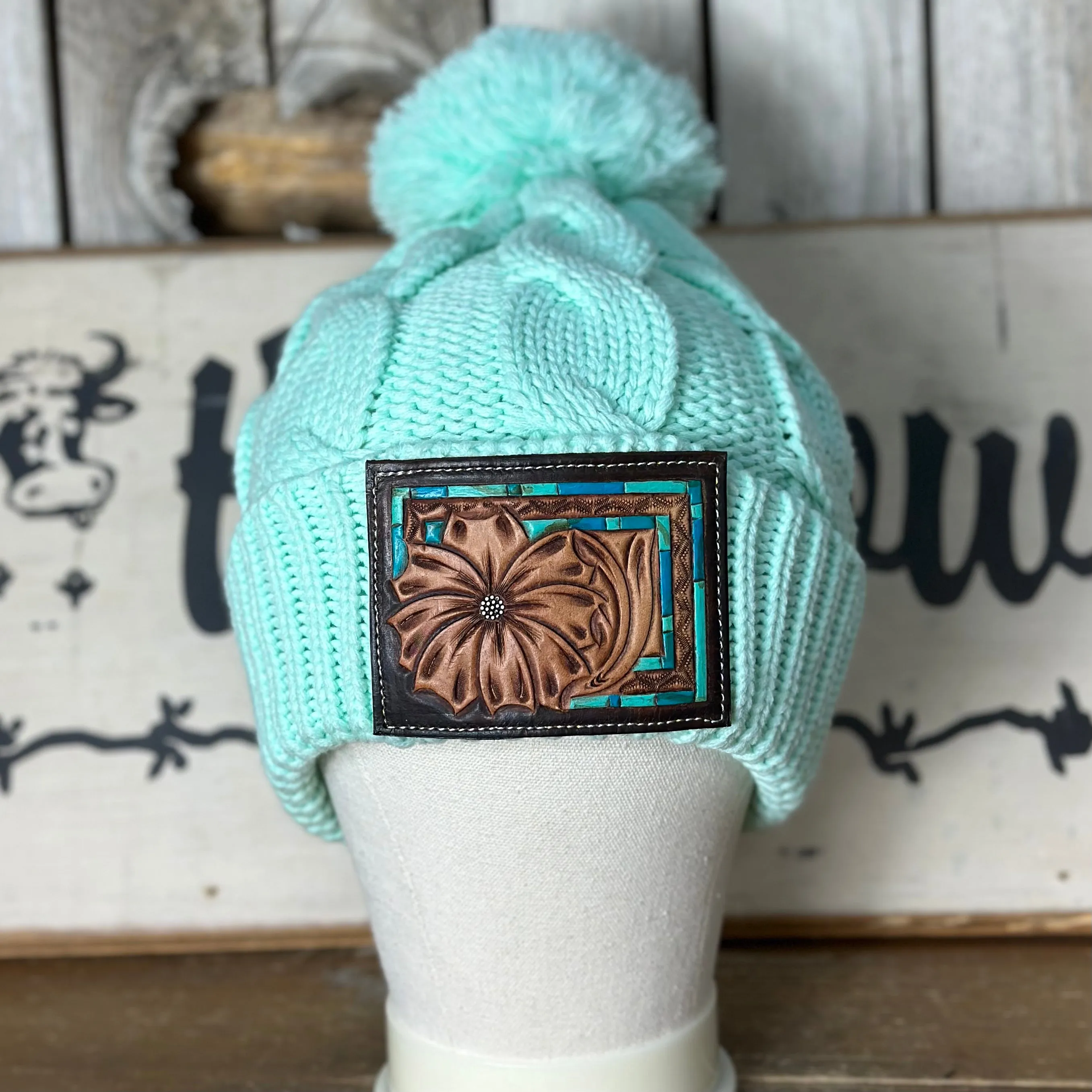 Amanda Rose Chunky Cable Knit Beanie w/ Pom and Hand Tooled Patch